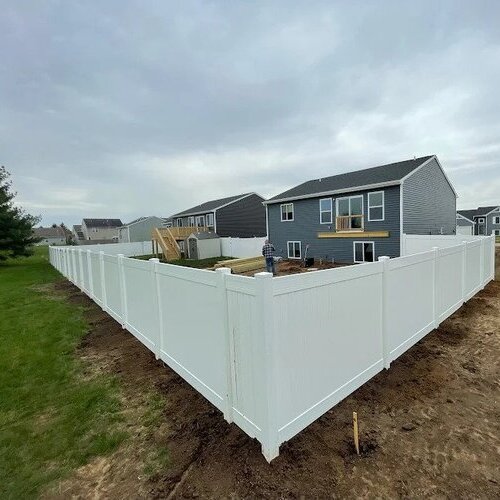 white vinyl fence in front of a home